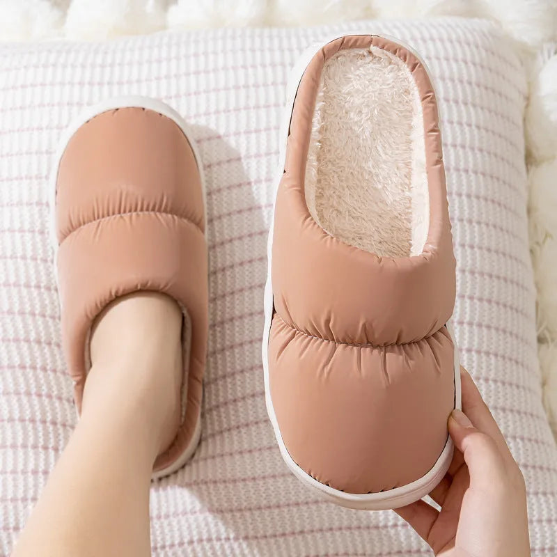 Blue winter slippers for indoor use with a thick rubber non-slip sole and artificial plush lining.