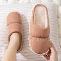 Blue winter slippers for indoor use with a thick rubber non-slip sole and artificial plush lining.