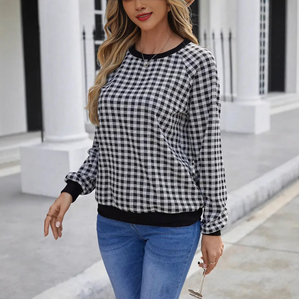 Black long sleeve plaid pullover sweater with Japanese style printing laid flat.