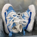 Women's grey retro chunky sneakers with thick rubber sole and high heel on a plain background