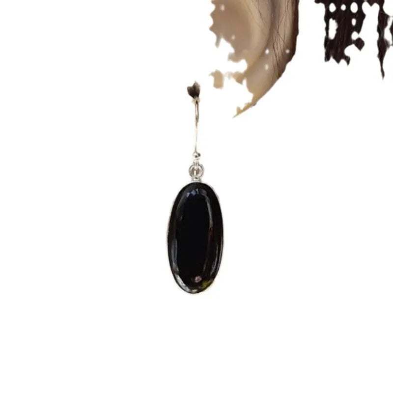 Black women's earrings with an oval black agate pendant on 925 silver, in a Chinese geometric style.