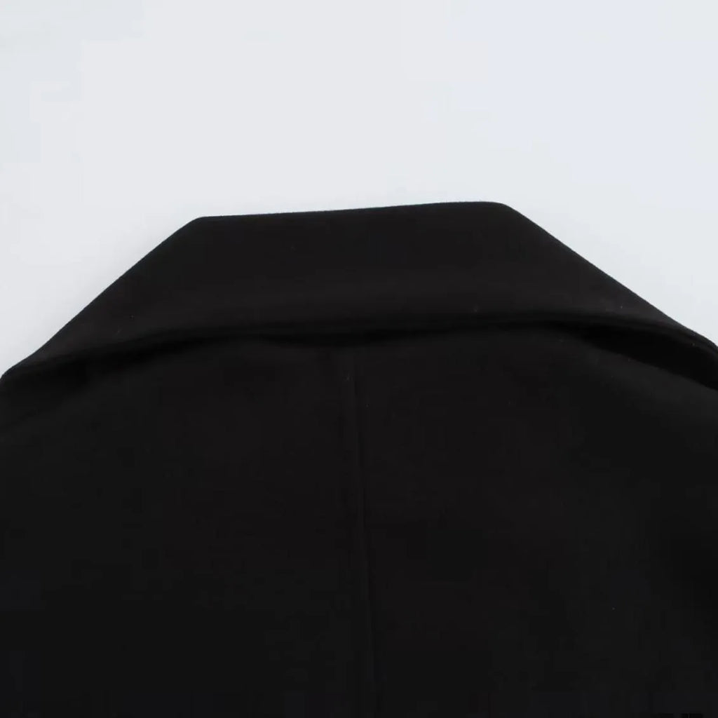 Women's long grey polyester overcoat with artificial fur collar and pockets, shown in a street fashion style.
