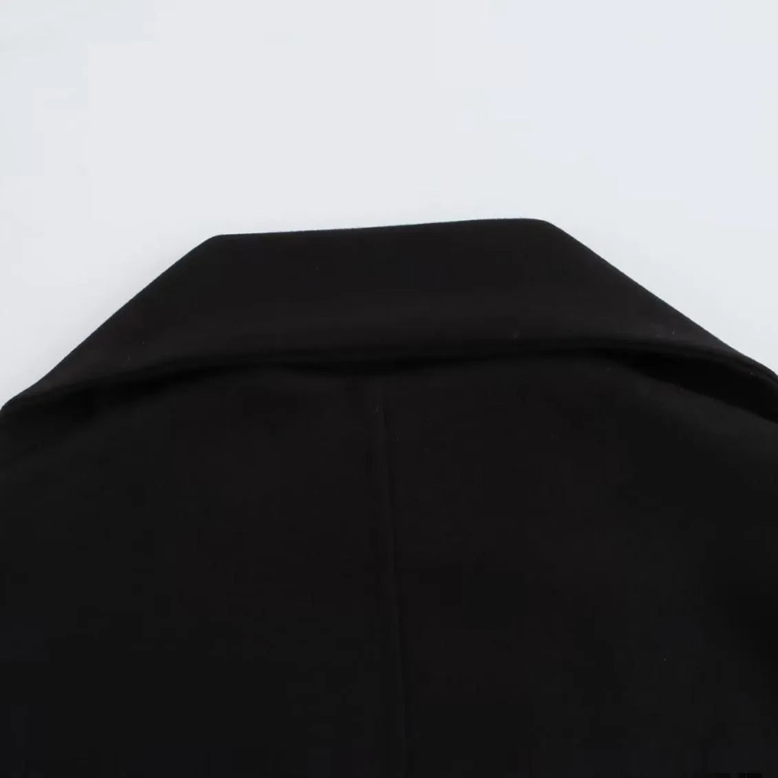 Women's long grey polyester overcoat with artificial fur collar and pockets, shown in a street fashion style.