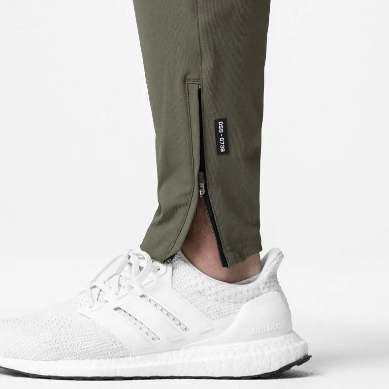 Men's grey loose-fit fitness trousers with ankle ties and quick-drying polyester fabric