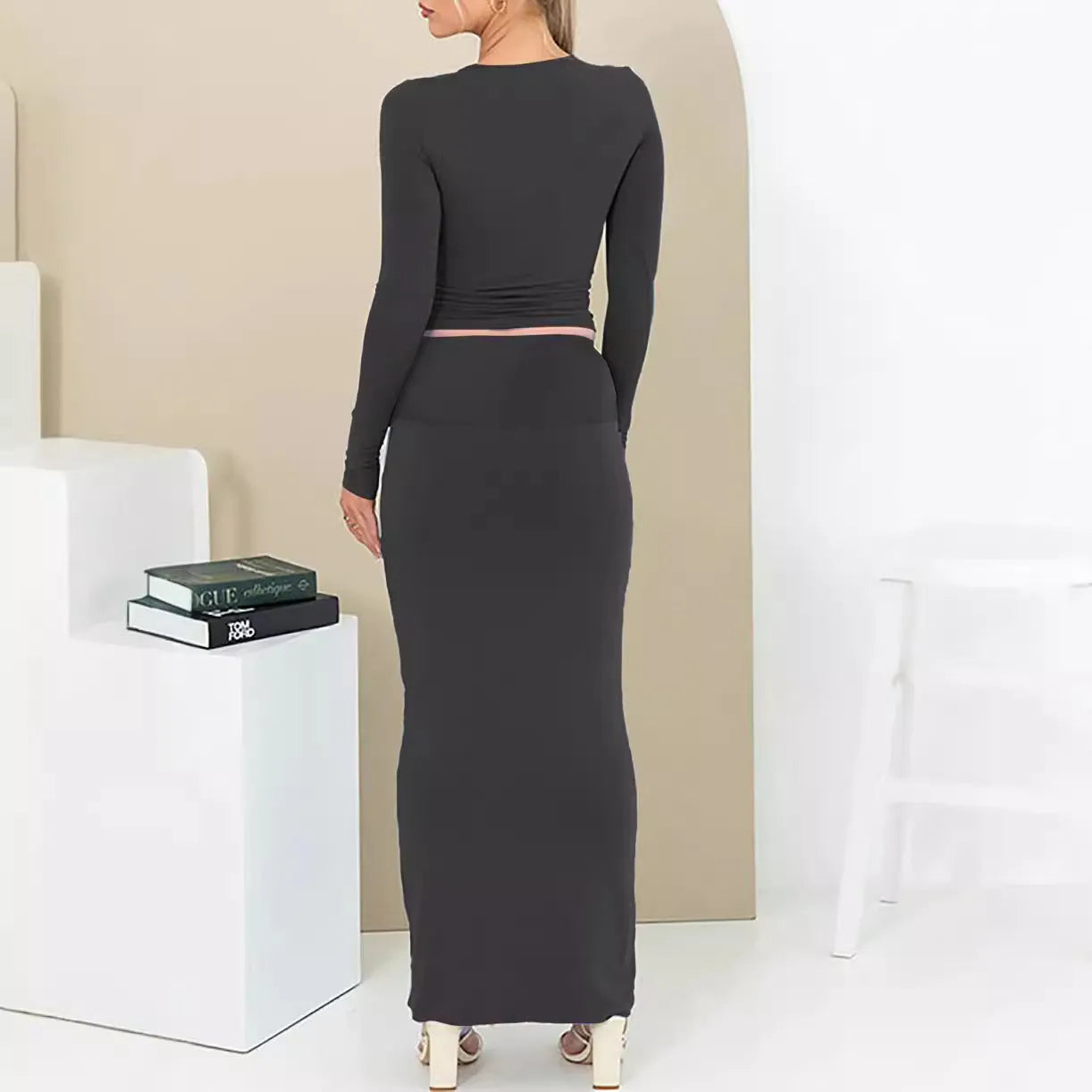 Women's slim fit polyester two-piece suit set with three-quarter sleeves and long skirt in black.