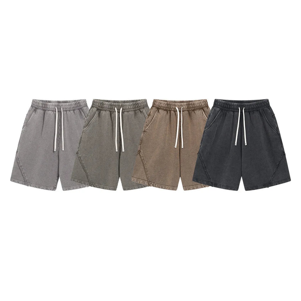 Man wearing retro-style batik washed grey-green cotton terry shorts with a loose fit.