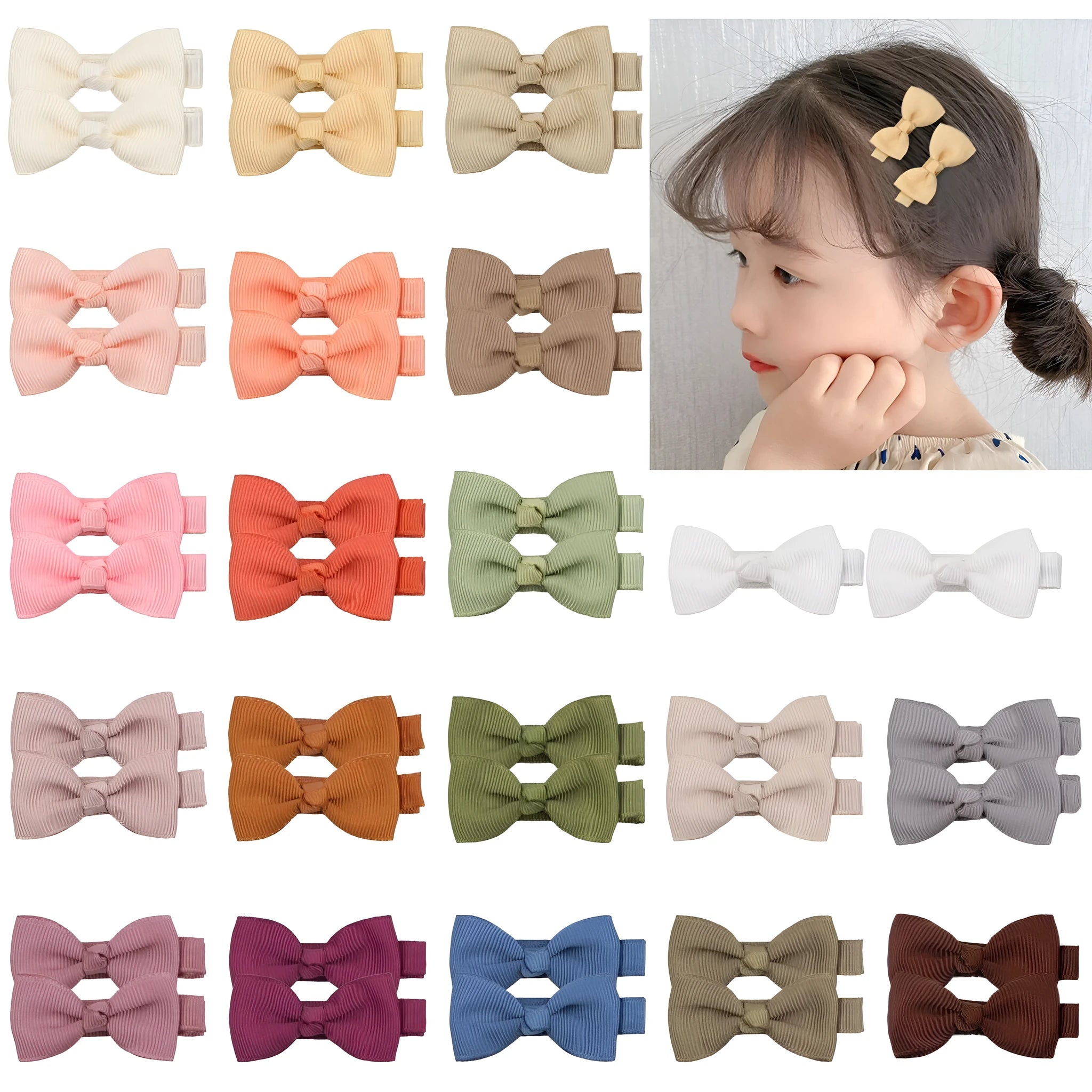 Assortment of pastel coloured baby hair clips and bows, including barrettes, laid out on a white background.