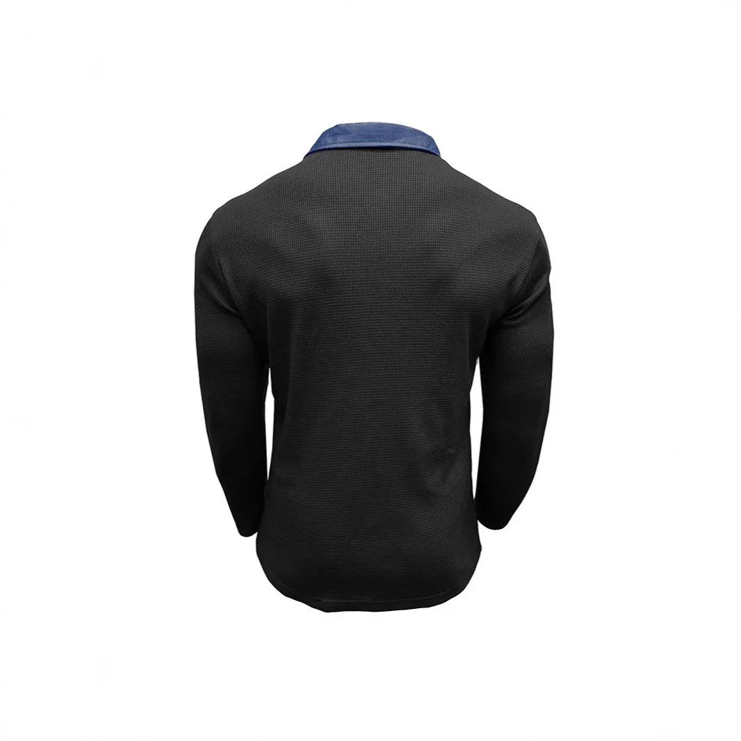 Man wearing a long-sleeved waffle-knit polo shirt in an asymmetric design, shown in a solid colour.