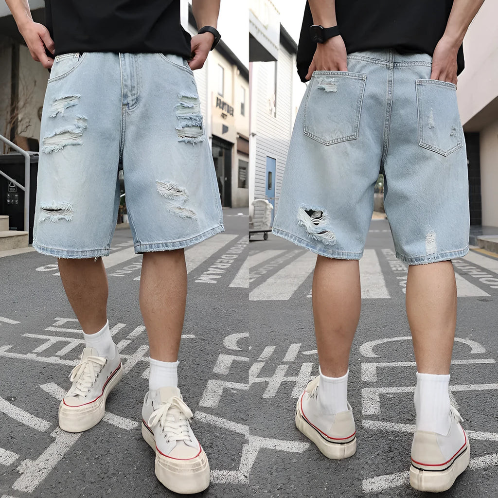 Light blue distressed denim shorts with ripped detailing and loose casual fit
