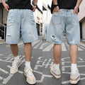 Light blue distressed denim shorts with ripped detailing and loose casual fit