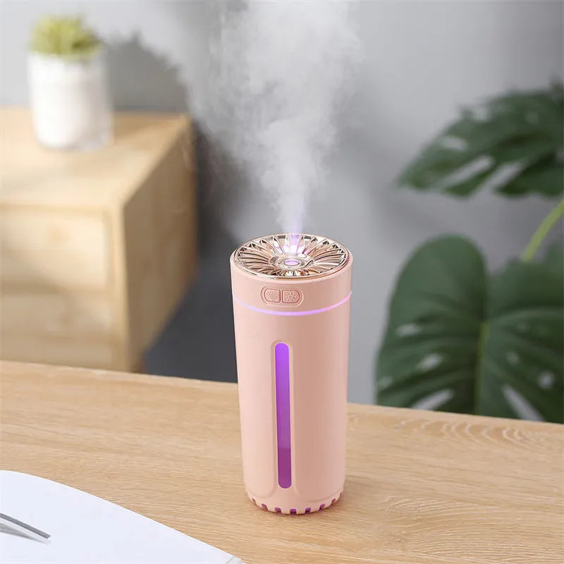Black portable car humidifier with colourful LED lights showing mist output, placed in vehicle cup holder