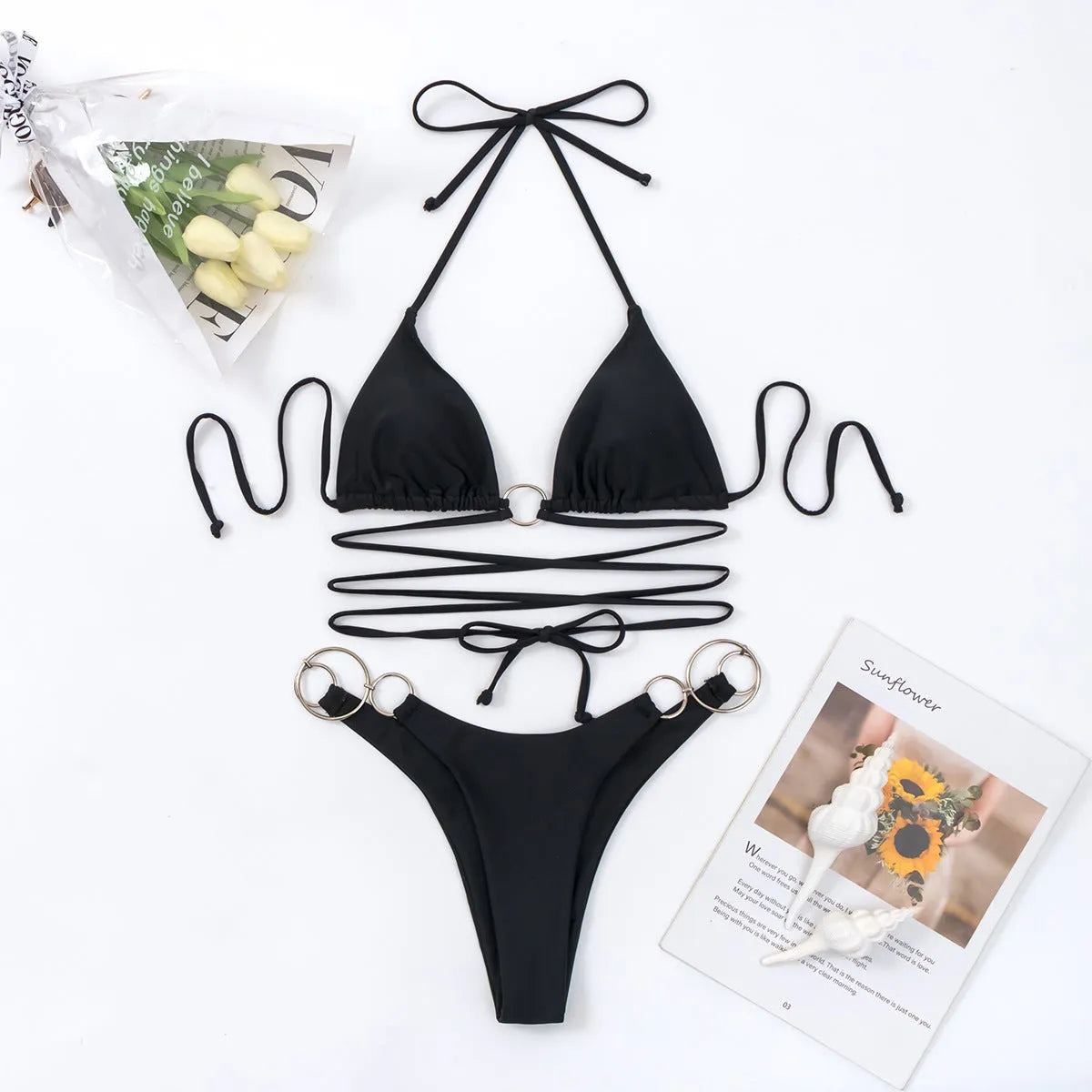 Black women's bikini swimsuit with metal rings and long adjustable straps on a mannequin.