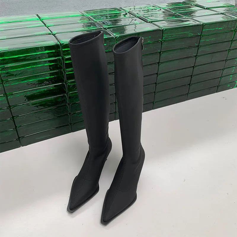 Black women's pointed toe below knee boots with a stiletto heel and a back zip fastener.