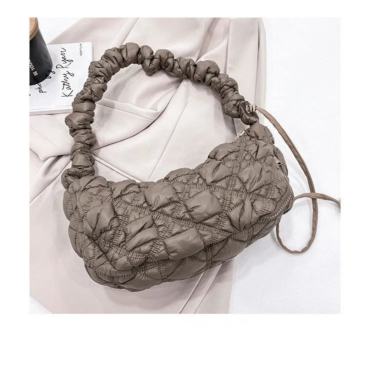 Beige nylon women's casual shoulder messenger bag with a long strap, shown from the side.