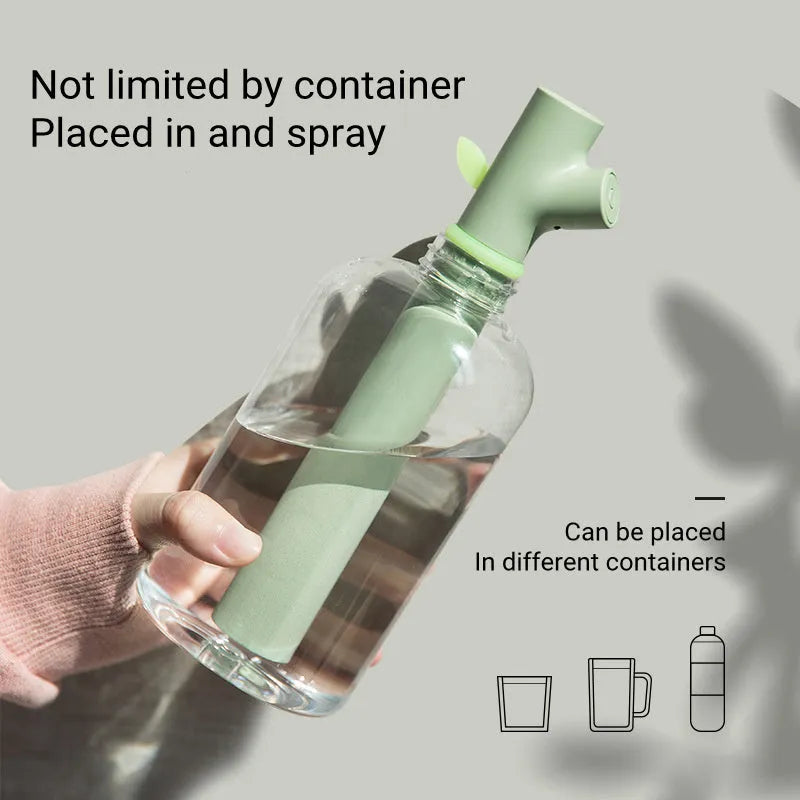 Transparent plastic branch-shaped USB portable air humidifier on a desk.
