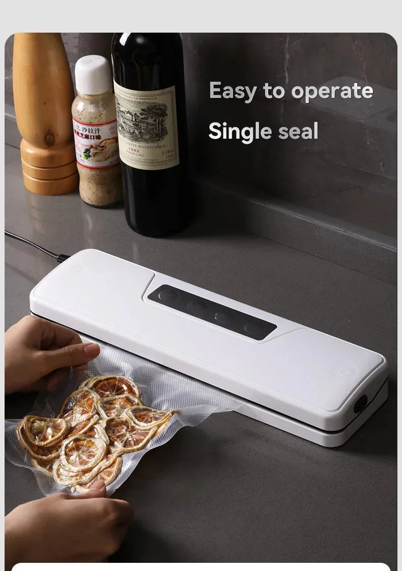 Small white automatic vacuum sealer machine for home food preservation on a kitchen counter.