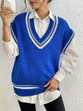 Blue loose-fit women's acrylic blend vest sweater on a hanger, college style.