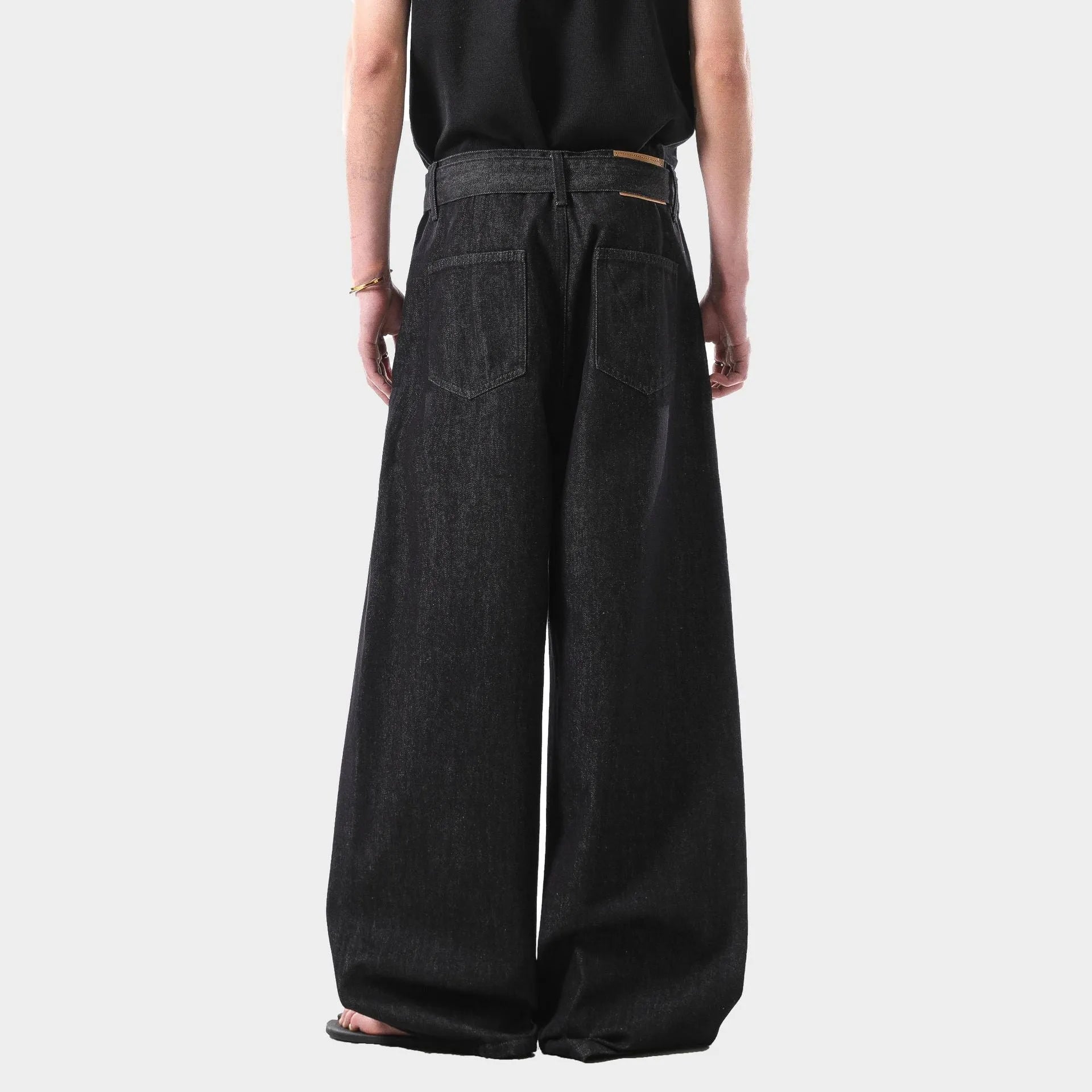 Black high waist straight-leg jeans with gold stitching on a mannequin