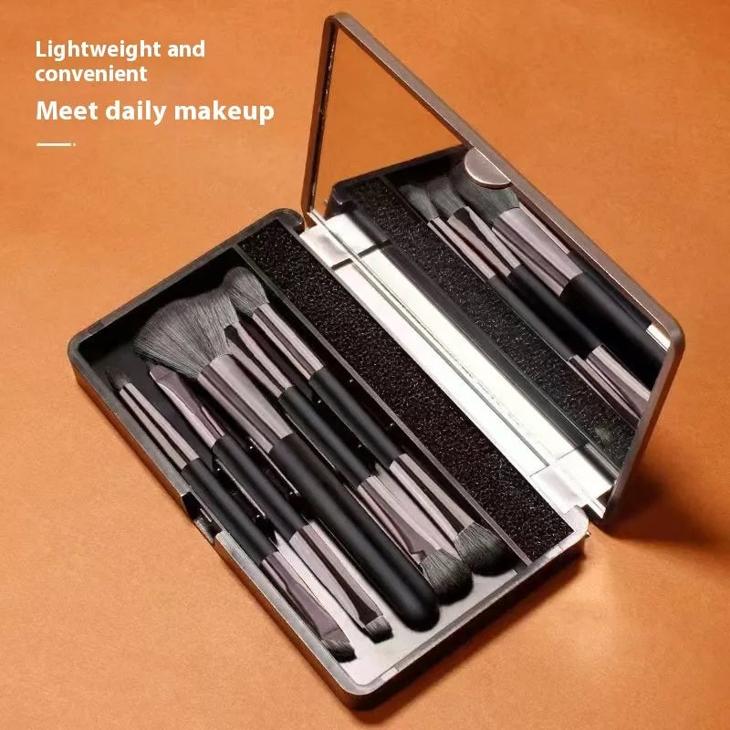 Makeup brush kit with mirror showing eyeshadow brushes with artificial fibre bristles and plastic handles