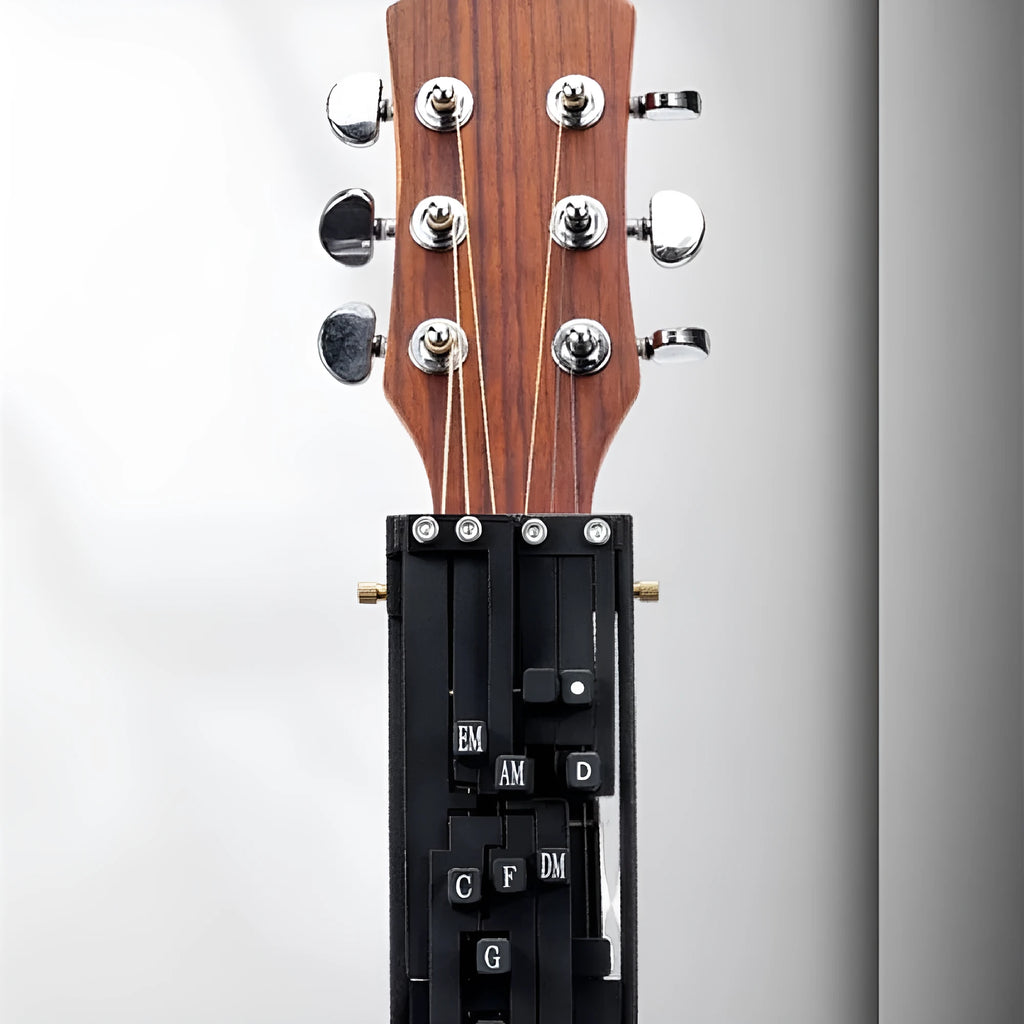 Black automatic guitar chord practice device for novice players on a folk guitar.