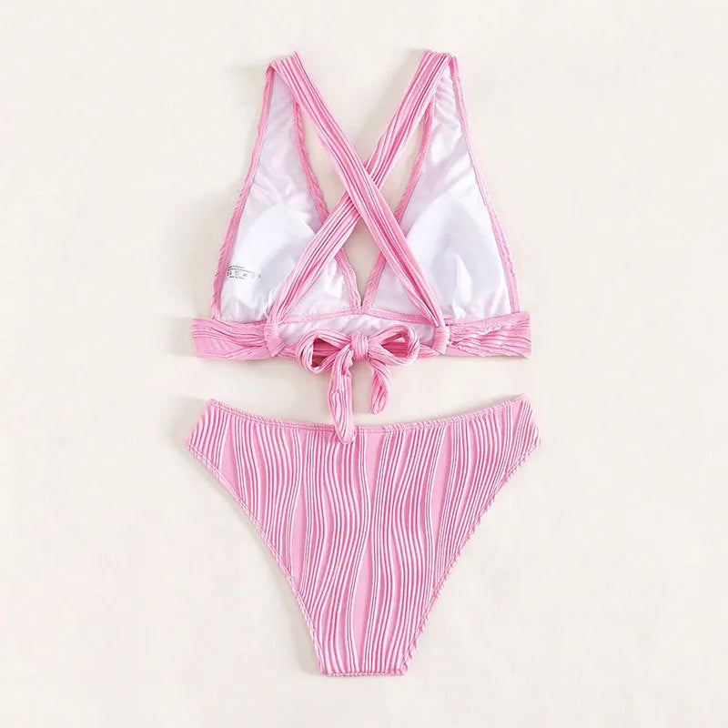 Women's pink halter strap bikini set with split shorts on mannequin display