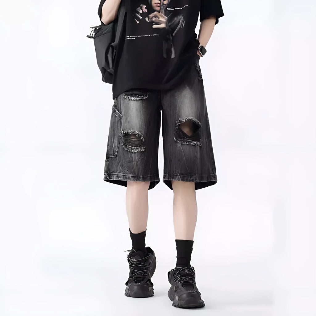 Man's washed blue denim shorts with ripped details and a loose, retro fit.
