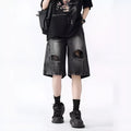 Man's washed blue denim shorts with ripped details and a loose, retro fit.
