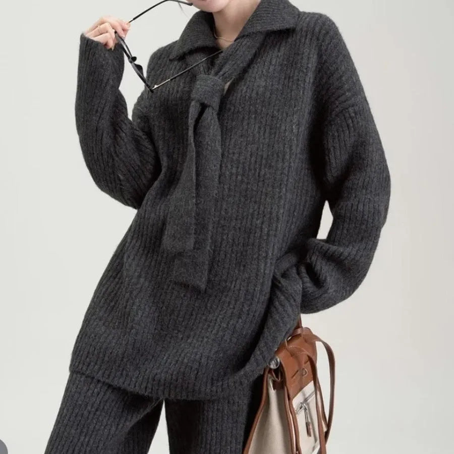 Women's dark grey knit top and trousers two-piece sweater suit set on a hanger