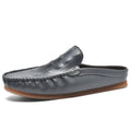 Men's black breathable semi-slippers with a rubber sole and artificial PU upper on a plain background.
