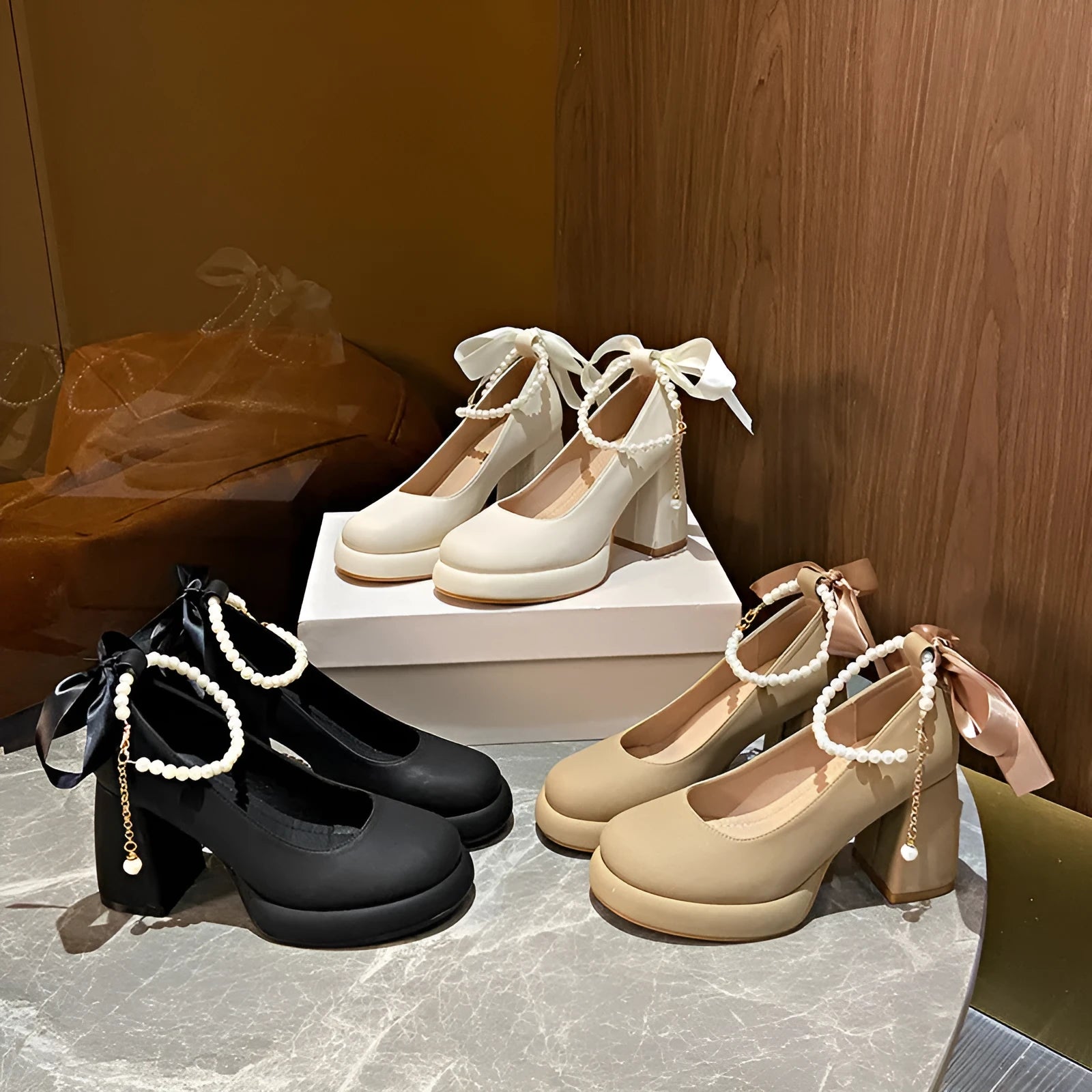 Beige women's Mary Jane shoes with a chunky heel and an ankle-strap buckle on a white background.