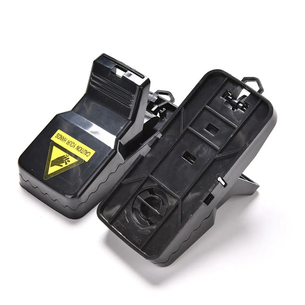 Six black plastic snapping mousetraps showing trigger mechanism and spring design