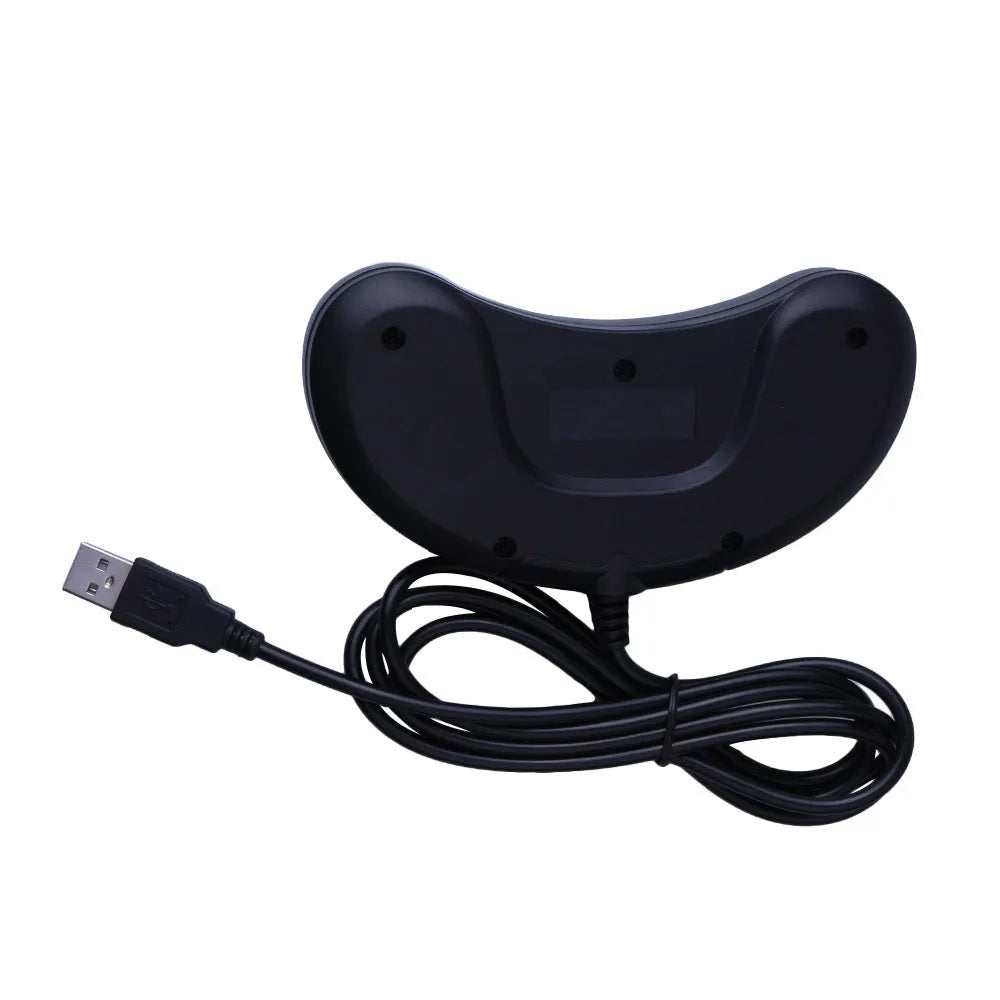 Black Sega USB PC gaming controller with long cable on a desk.