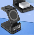 Black magnetic three-in-one 15W wireless charger with clock on a desk