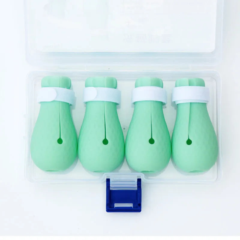 Green silicone cat paw covers with straps for scratch protection during washing and medical procedures