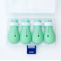 Green silicone cat paw covers with straps for scratch protection during washing and medical procedures