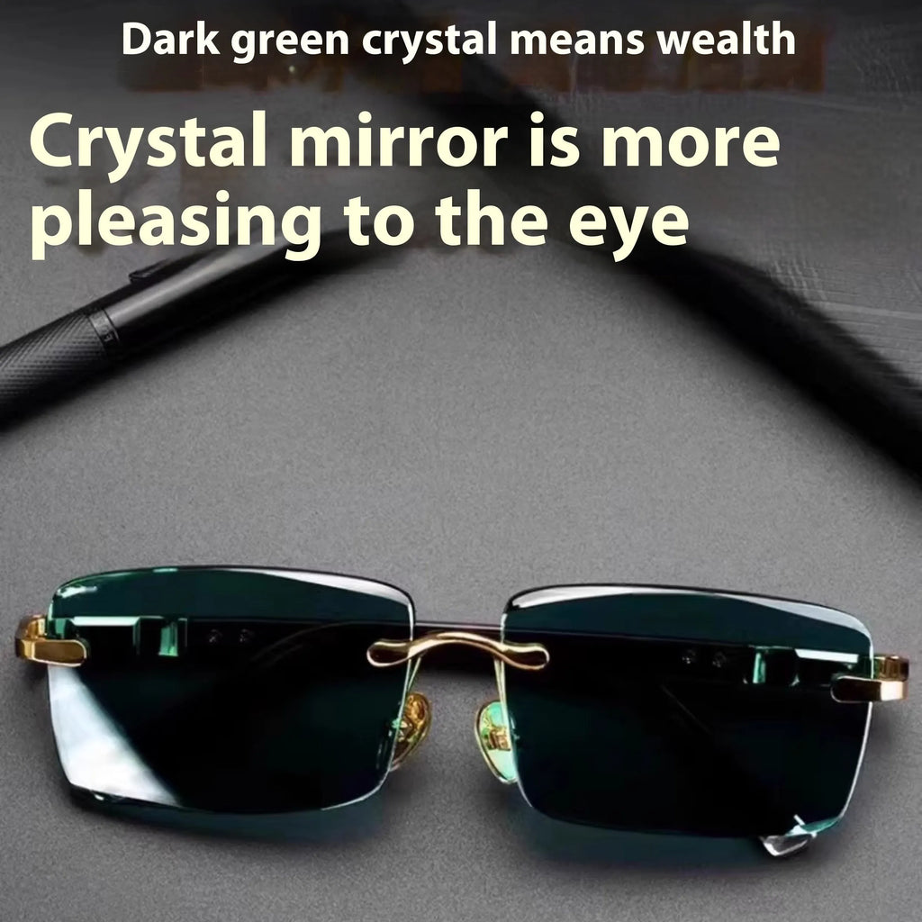 A pair of dark green frameless crystal sunglasses presented with a matching glasses case and a lens cloth.