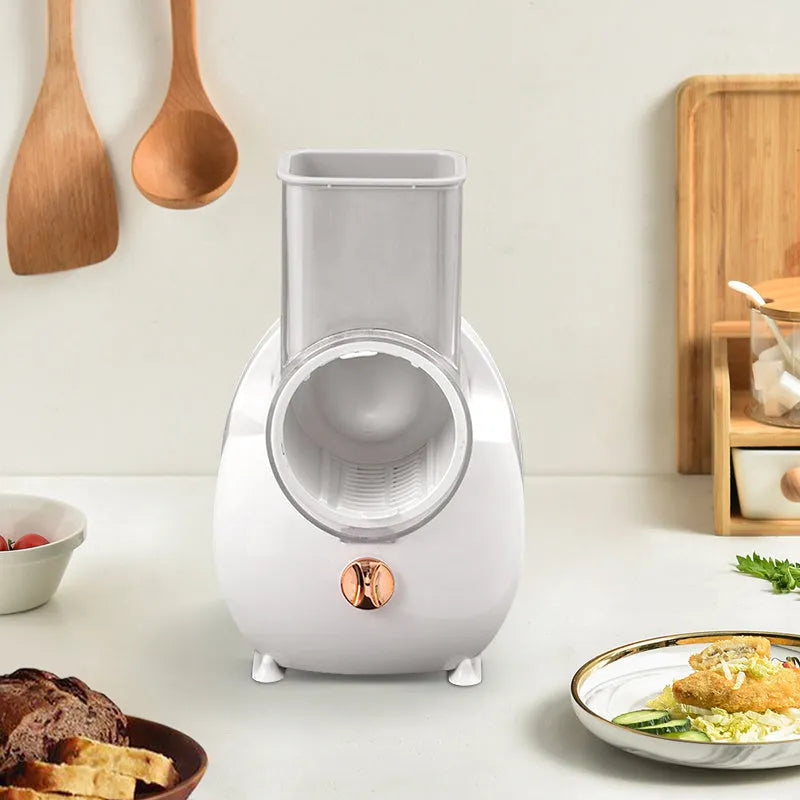 White electric vegetable slicer with suction base and multiple blades for potato and carrot cutting