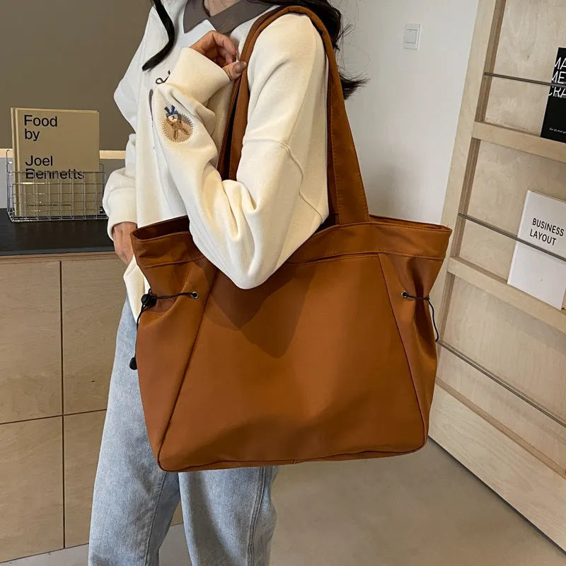 Oxford cloth folding shoulder tote bag in a choice of five colours including black, brown, and purple.