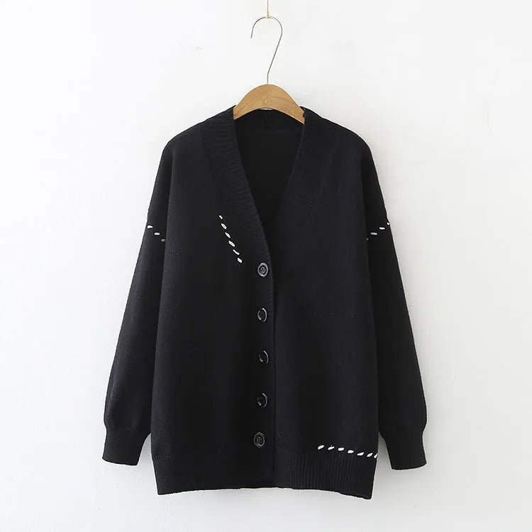 Women's loose black knitted cardigan with long sleeves on hanger