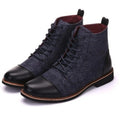 Men's large black leather motorcycle boots with belt buckle detail and a thick rubber sole.