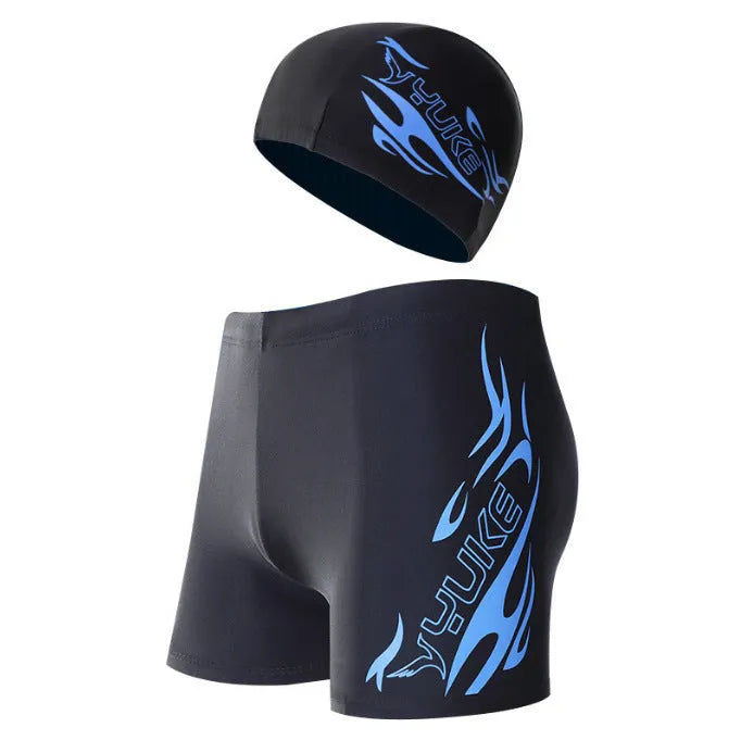 Men's red and blue fire pattern boxer swimming trunks with matching cap on black background.