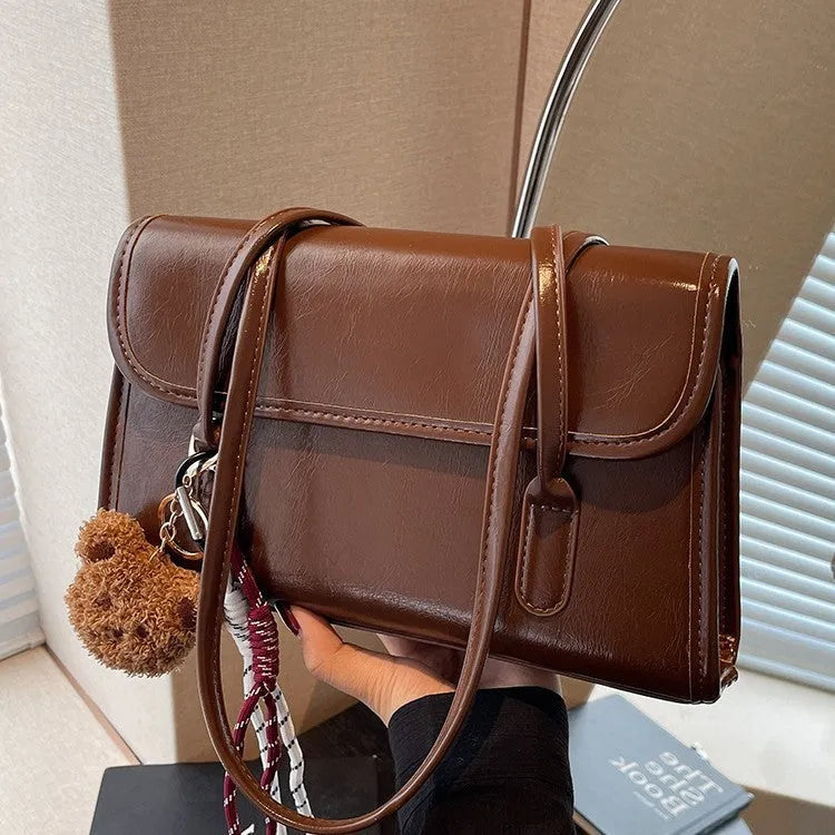 Women's brown PU leather square shoulder bag with decorative pendant and double strap