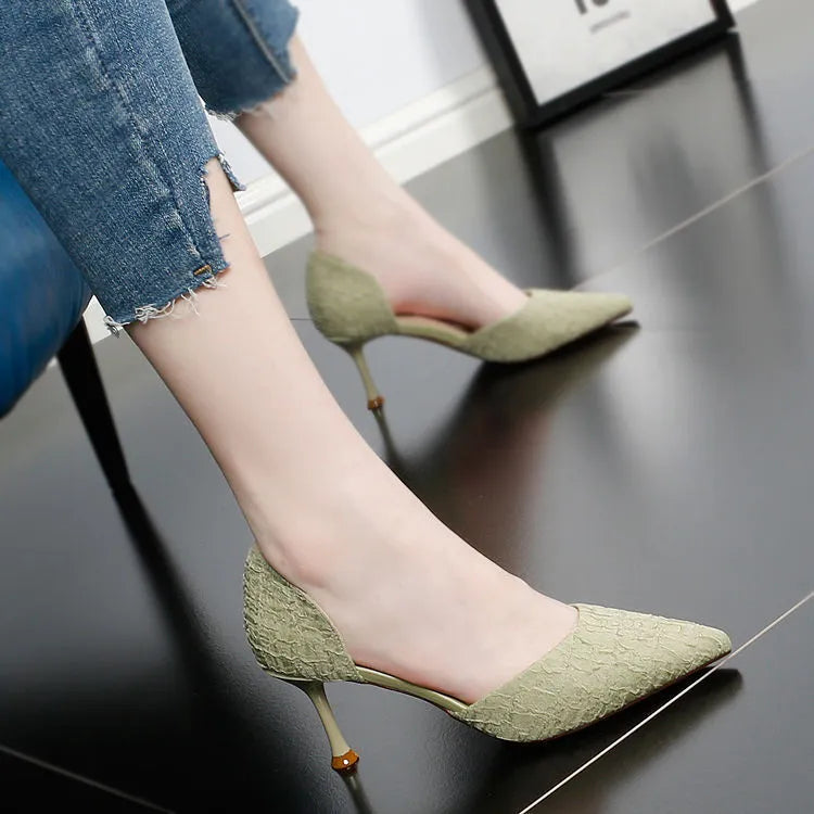 Women's black PU leather pointed toe stiletto high heels on a light background