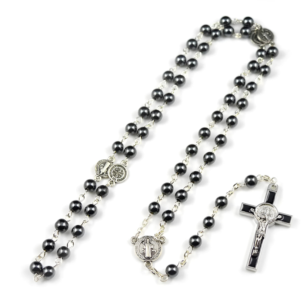Black rosary necklace with hematite beads and zinc alloy cross on plain background