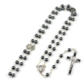 Black rosary necklace with hematite beads and zinc alloy cross on plain background
