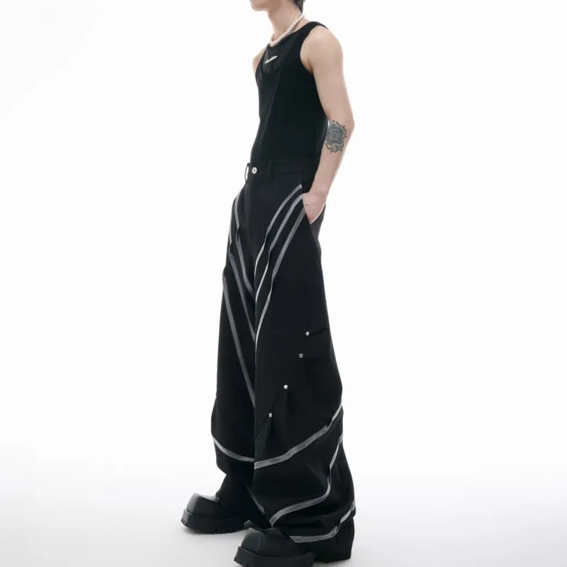 Men's black trousers with metal striped rivets and pleated design detail