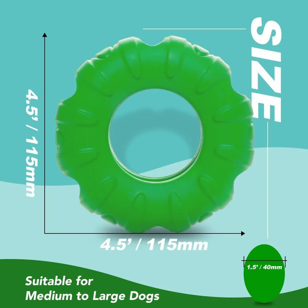Blue rubber tyre-shaped dog chew toy and slow feeder with oval openings on a wooden floor.