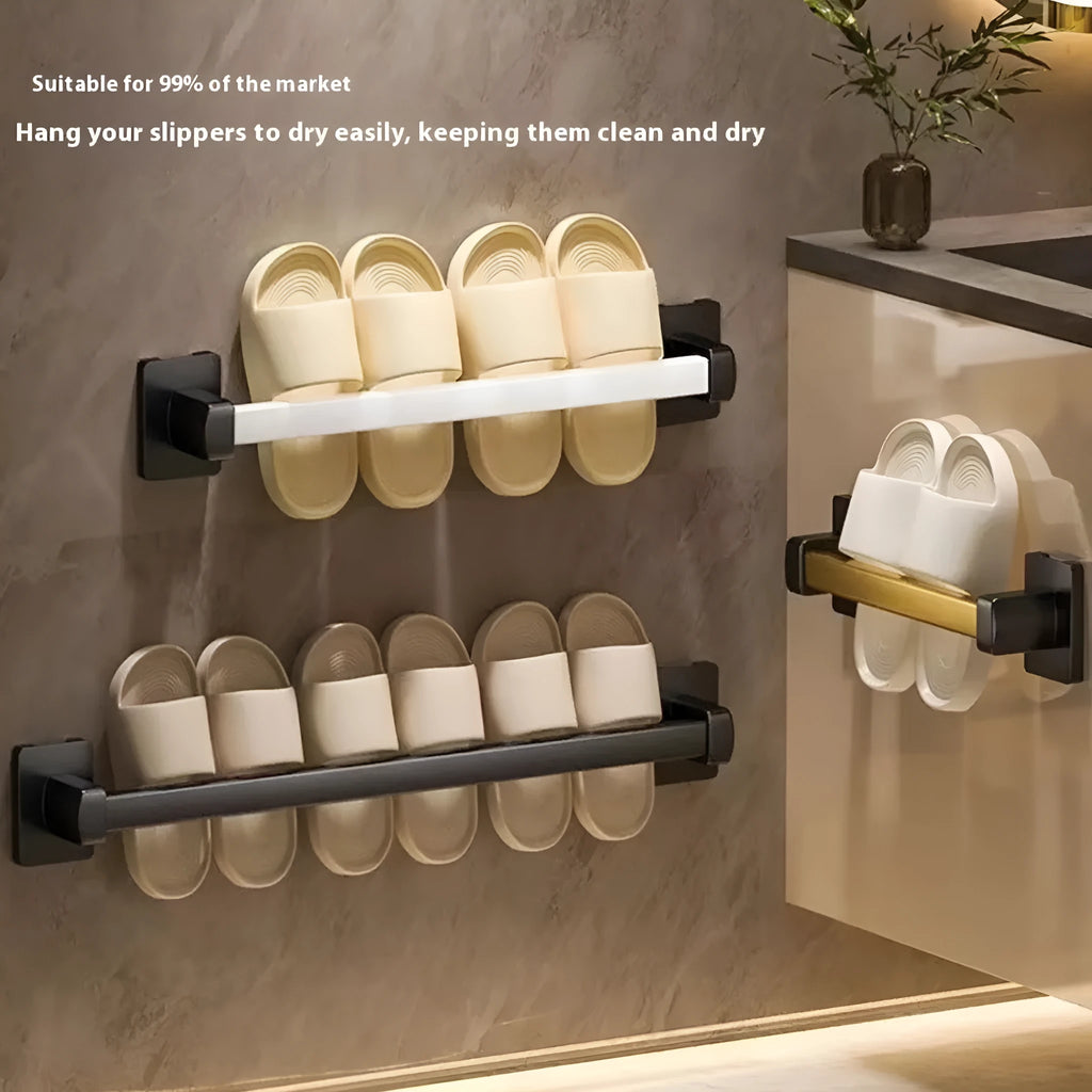 Black wall-mounted bathroom slipper rack with a small integrated seat, showing adhesive backing for punch-free installation.