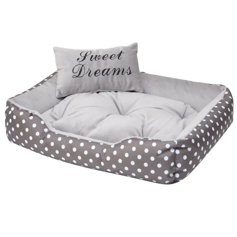 Polka dot printed cloth dog bed with matching embroidery pillow for a small dog.