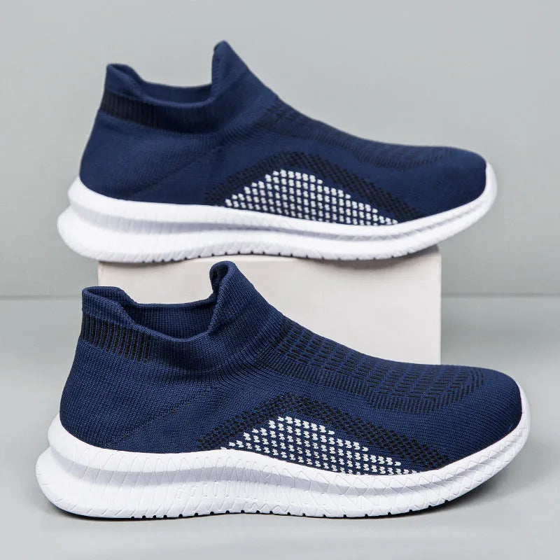 Men's white, black, and blue fabric flyknit low-top casual sneakers with round toe on a plain background